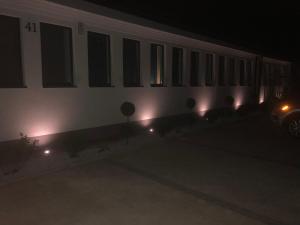 a white train car with lights on it at night at M&A GUEST ROOMS in Łomża