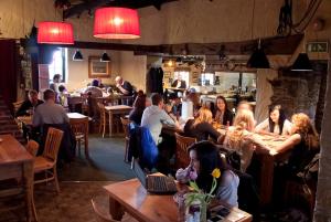 a group of people sitting at tables in a restaurant at Tricky's Hotel in Redruth