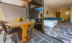 a living room with a table and a couch at Apollonia Hotel Apartments in Varkiza