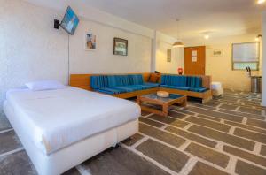 a hotel room with a bed and a couch at Apollonia Hotel Apartments in Varkiza