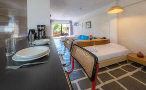 a room with a bed and a kitchen with a table at Apollonia Hotel Apartments in Varkiza +37 photos