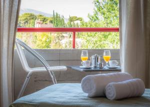 a room with a table with two glasses of orange juice at Apollonia Hotel Apartments in Varkiza