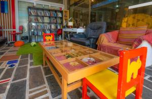 a living room with a table and a couch at Apollonia Hotel Apartments in Varkiza