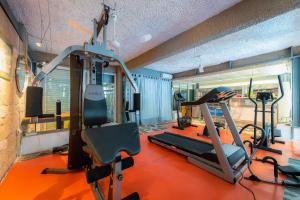 a gym with two tread machines and a treadmill at Apollonia Hotel Apartments in Varkiza