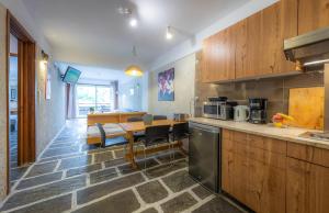 a kitchen with a table and a counter top at Apollonia Hotel Apartments in Varkiza