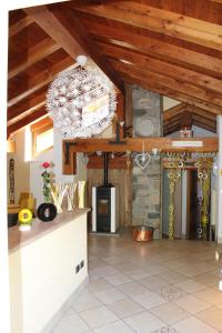 a kitchen with a stone fireplace and a chandelier at Villetta relax in Aosta
