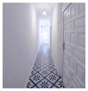 a hallway with a blue and white tile floor at Casa Lagunera in Las Lagunas