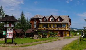 a large house on the side of a road at Guest house Dvir Pysanka in Kosiv