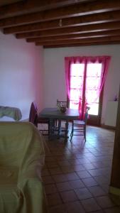 a dining room with a table and a window at chez sylvie et jean-yves in Chagny