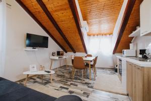 a kitchen and dining room with a table and a tv at Apartment Toma in Trogir