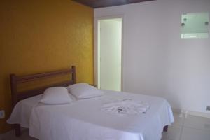 A bed or beds in a room at Pousada Vida Boa