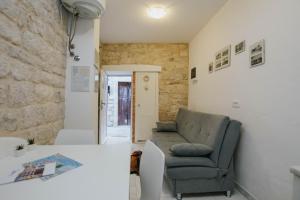 a living room with a couch and a table at Apartment Toma in Trogir