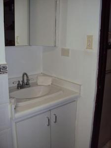 a bathroom with a sink and a mirror at Non Stop party Apartment Condo in San Juan