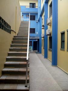 a set of stairs next to a blue building at 27 Praia Hotel - Frente Mar in Bertioga