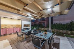 a patio with a table and chairs in a room at Villa Marivel in Privlaka