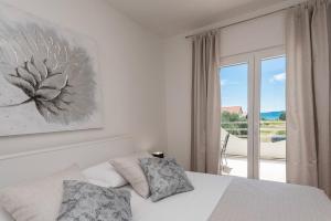 a bedroom with a bed and a large window at Villa Marivel in Privlaka +79 photos