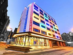 a tall building with colorful windows in a city at Whoops Hotel in Taichung