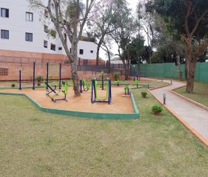 a playground in a park with swings and a monkey at Departamento amoblado en condominio cerrado! Un lugar ideal para instalarse! in San Lorenzo