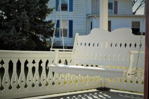a white fence in front of a house at Hawksbill House - (Adults Only) in Luray