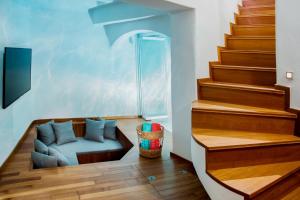 a living room with a couch next to some stairs at Sweet Nectar Villa with Hot Tub in Pyrgos