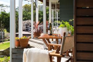 a patio with a table and chairs on a porch at Old Chilli Daylesford in Daylesford