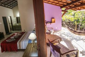 a bedroom with a bed and a balcony at Chalés Ima Teva in Lençóis