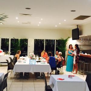 a group of people sitting at tables in a restaurant at Swag Motel in Middlemount +7 photos