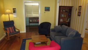a living room with a couch and a chair at The Blue House Yungaburra in Yungaburra