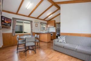 a living room with a couch and a table at Lake Hamilton Motor Village and Caravan Park in Hamilton