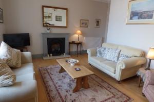 a living room with a couch and a coffee table at Abbey View in Kelso