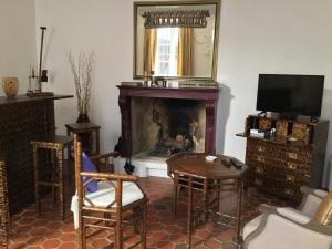 a living room with a fireplace and a tv at Maison de village Novissime in Noves