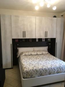 Schlafzimmer mit einem Bett mit weißen Schränken in der Unterkunft appartamento - Casa la botola - in Alba