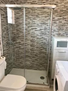 a shower stall in a bathroom with a toilet at LOS ANGELES APARTMENT Los Cristianos in Los Cristianos