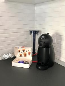 a coffee maker sitting next to a box of cupcakes at LOS ANGELES APARTMENT Los Cristianos in Los Cristianos