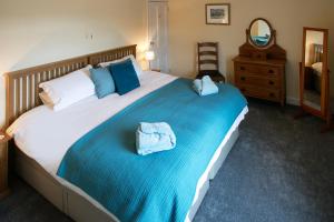 a bedroom with a large bed with two towels on it at BELLE VUE - SKIPTON in Skipton