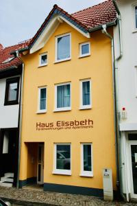 un edificio amarillo con las palabras hos elsiebeit en Haus Elisabeth, en Bad Salzungen
