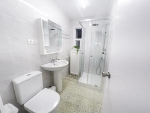 a white bathroom with a toilet and a shower at carpe diem beach front cat in Port de la Selva