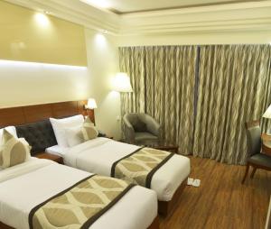 Postel nebo postele na pokoji v ubytování Hotel Regent Grand