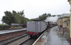 a steam train is pulling into a train station at BELLE VUE - SKIPTON in Skipton