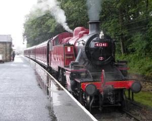 a steam engine train is coming down the tracks at BELLE VUE - SKIPTON in Skipton