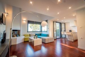 a living room with a couch and a table at Pleiades Boutique Villas in Kriopigi