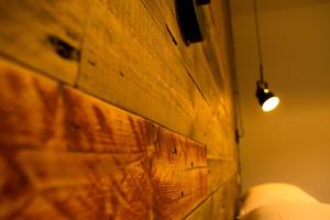 a light on a wooden wall next to a lamp at S'accabbadora Guest House in Alghero