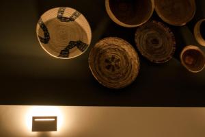 a group of hats hanging on a wall at S'accabbadora Guest House in Alghero