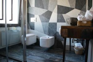 a bathroom with a shower and a toilet and a sink at S'accabbadora Guest House in Alghero