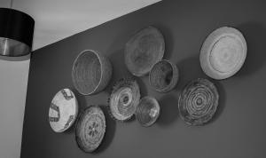 a bunch of old hats hanging on a wall at S'accabbadora Guest House in Alghero