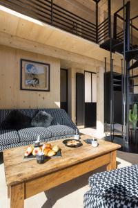 a living room with a table with food on it at Refuges en ville in Bourg-Saint-Maurice