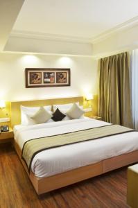 Ένα ή περισσότερα κρεβάτια σε δωμάτιο στο Hotel Regent Grand
