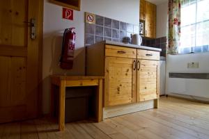 a kitchen with a wooden desk and a refrigerator at Chatka 428 a 429 - Tatralandia in Liptovský Mikuláš +21 photos