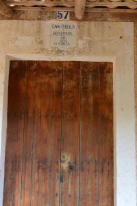 a wooden door in a building with a sign on it at Finca CanFirella Portocolom in Felanitx +48 photos