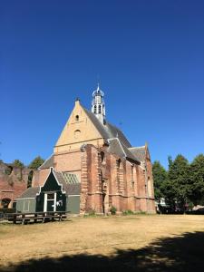 a large brick building with a tower on top of it at ECHT-Bergen in Bergen